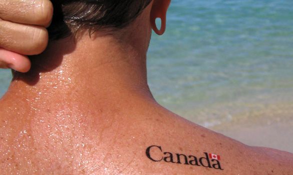 the back of a person's head with a canadian flag tattoo