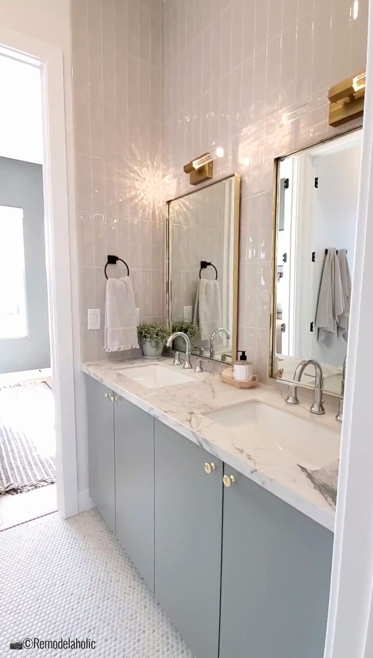 a bathroom with two sinks and mirrors in it