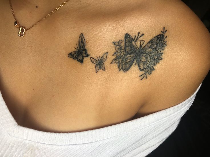 a woman's shoulder with three butterflies on it