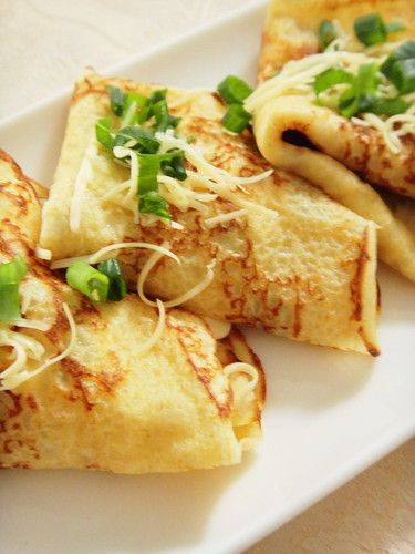 some food is on a white plate with green garnish and sprinkles