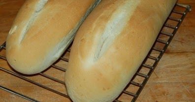 two loaves of bread sitting on a cooling rack