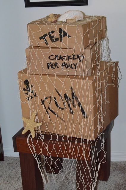 cardboard boxes stacked on top of each other with graffiti written on them and wrapped in netting