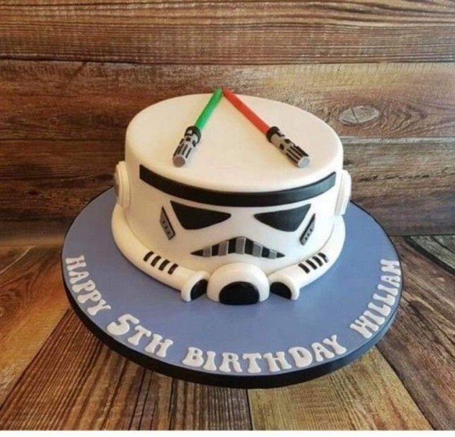 a star wars themed birthday cake on a wooden table