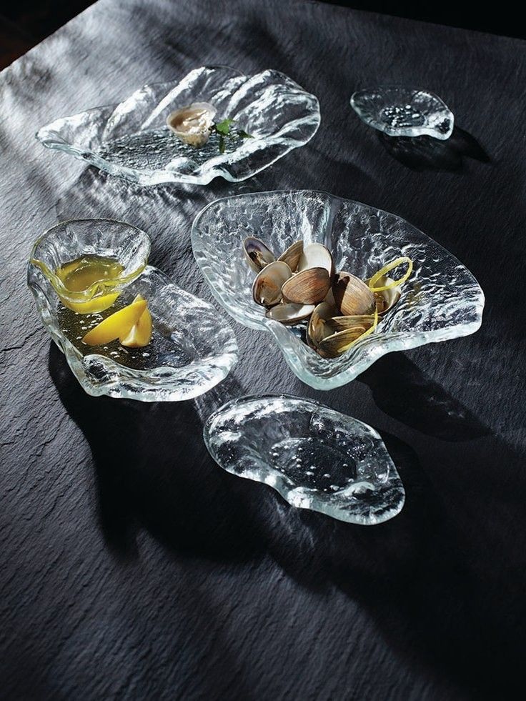 three glass bowls filled with food on top of a table