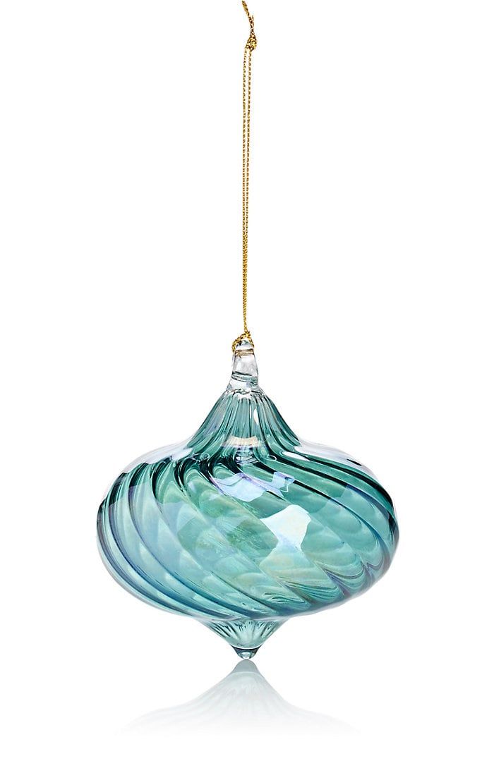 a blue glass ornament hanging from a gold - plated chain on a white background