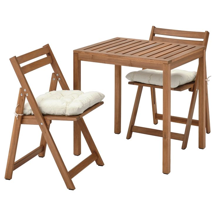 a wooden table with two chairs and a cushion on the seat pad, both side by side