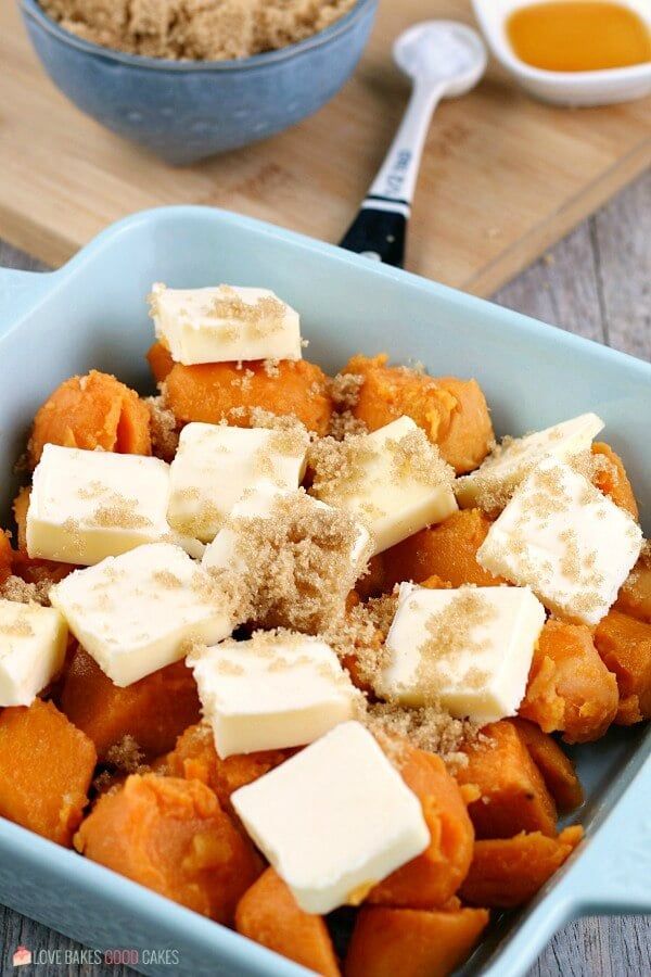 a blue bowl filled with sweet potatoes and butter