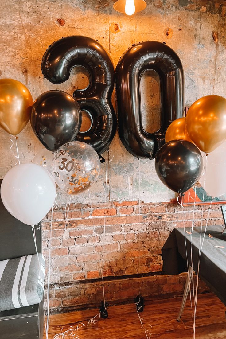 balloons and streamers in the shape of the number 30 are on display at a 30th birthday party