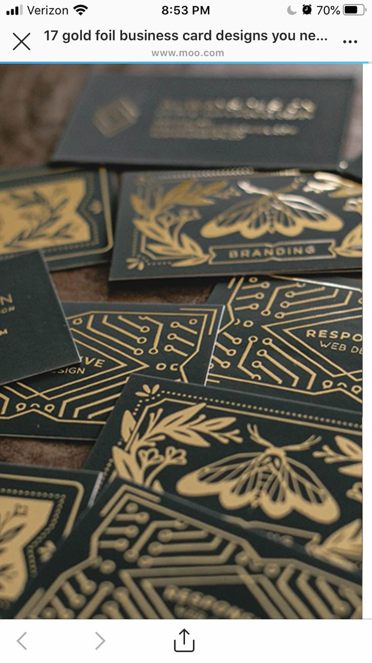 several black and gold business cards laying on top of each other