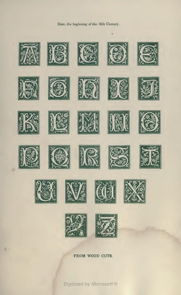 an old book with some type of letters on the front and back pages, all in green