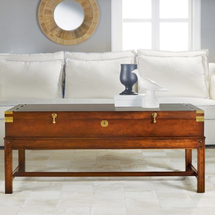 a living room with white couches and a coffee table