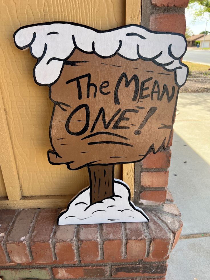 a wooden sign that says the mean one on it