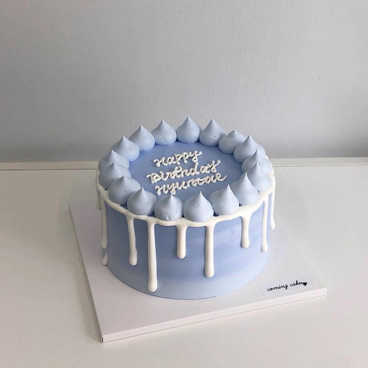 a birthday cake with white icing and blue frosting