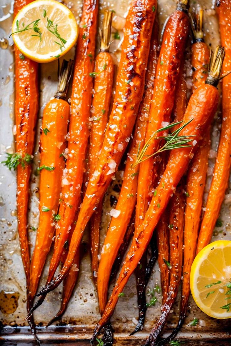 roasted carrots with lemon and herbs on a baking sheet