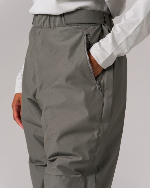 The FR 2L Down Pants are durable, insulated pants. The pants offer wind resistance, water resistance, and fire resistance from recycled ripstop polyester and aramid fabric. The FR 2L Down Pants have an adjustable elastic waist, zip, and button closure, dual waist pockets, full-length side zippers, back pocket, and elastic hem. Side Zipper, Black Pants, Elastic Waist, Full Length, Elastic, Zipper, Water, Pants, Fabric