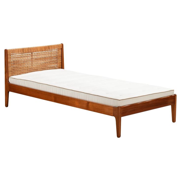 the bed frame is made from wood and wicker