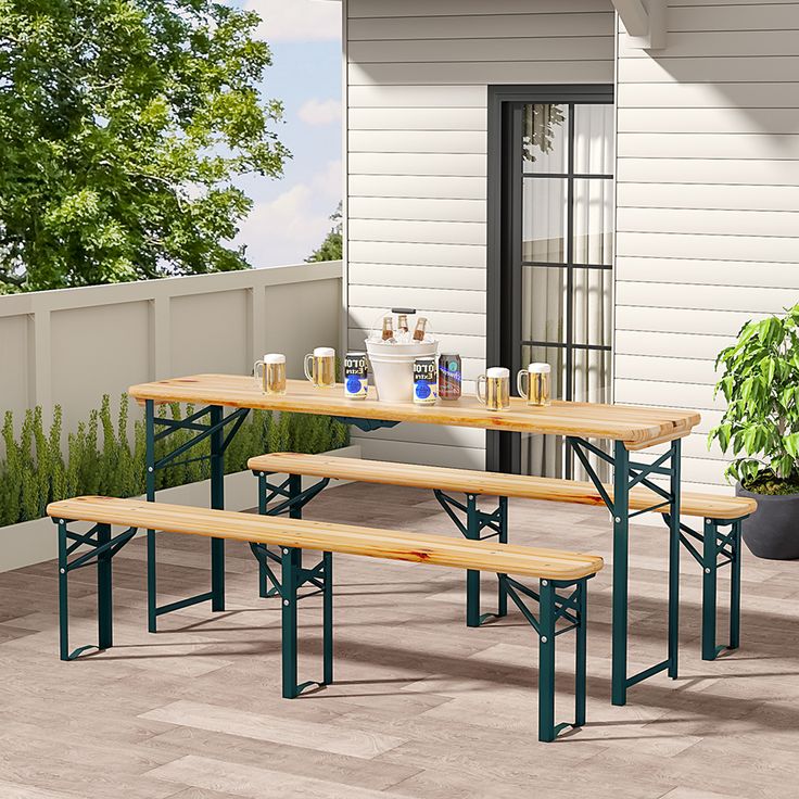 two wooden benches sitting next to each other on top of a patio near a potted plant