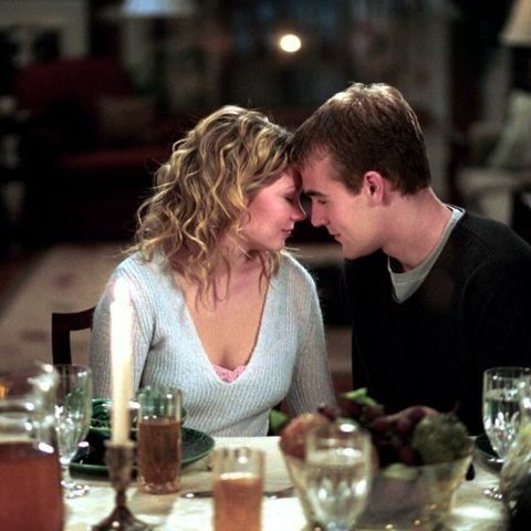 a man and woman sitting at a dinner table