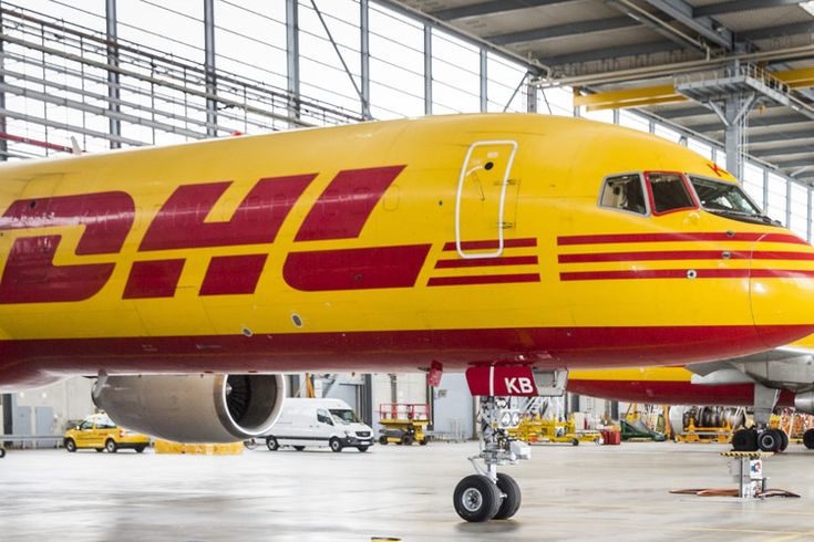 a large jetliner sitting inside of an airport hangar