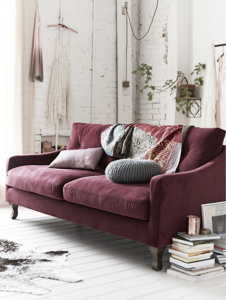 an image of a living room setting with couches and rugs in various colors