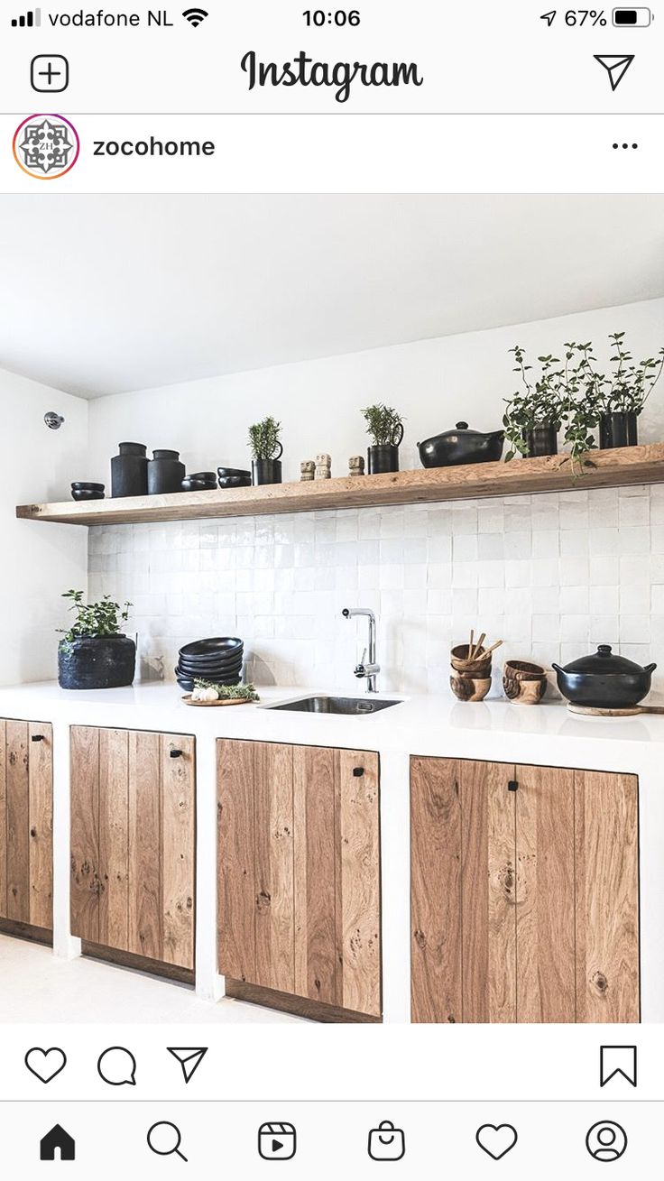 the instagram page shows an image of kitchen cabinets with plants and pots on them