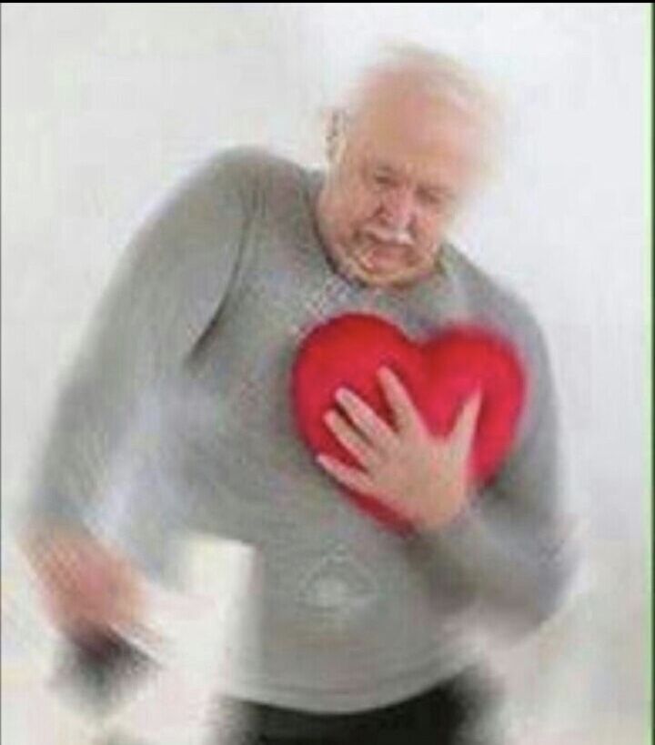 an old man holding a red heart in his hands