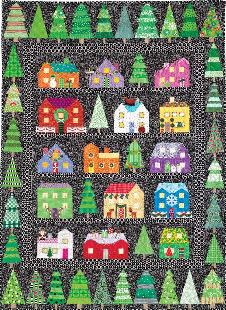 a quilt with houses and trees on it