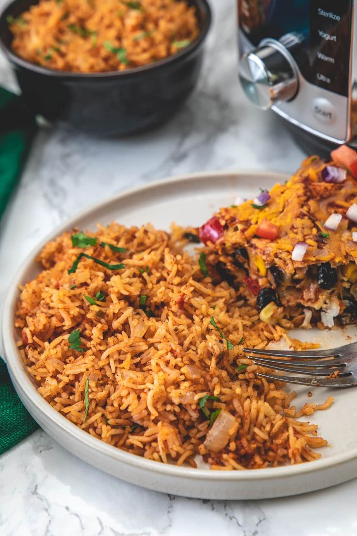 a white plate topped with rice next to a crock pot