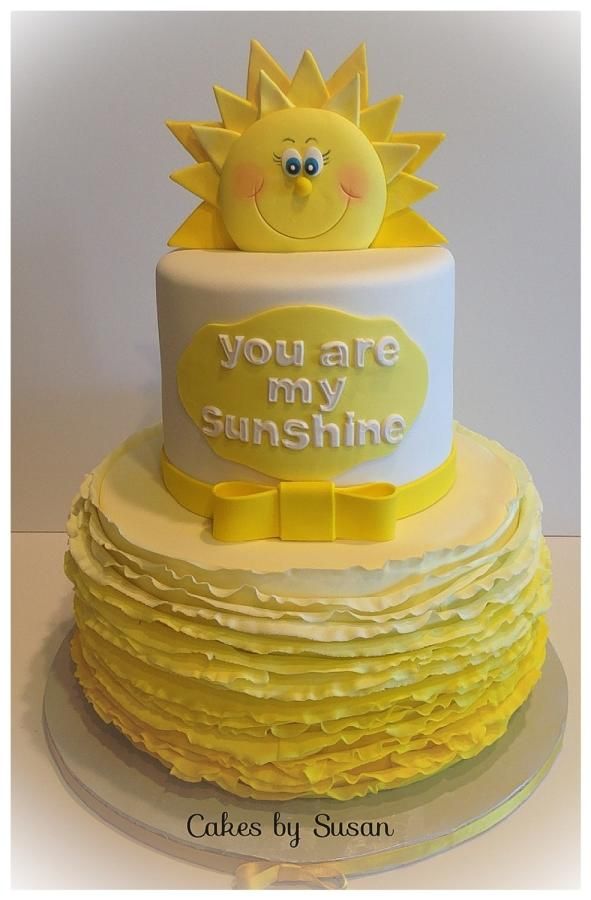 a yellow and white cake with the words you are my sunshine on it's side