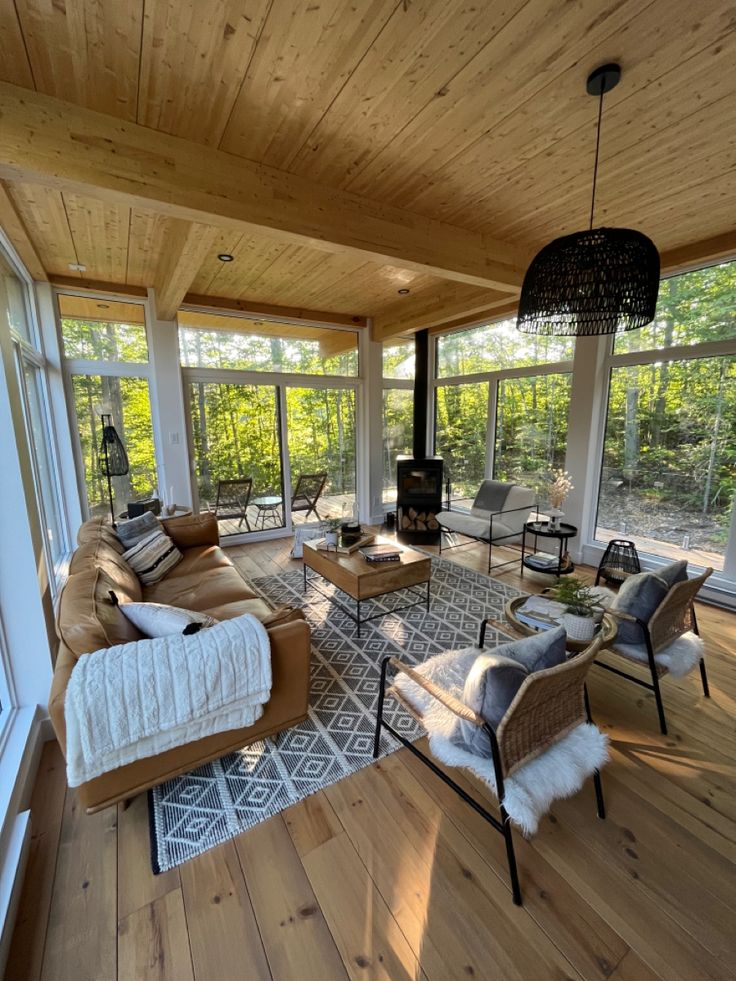 a living room filled with furniture and lots of windows