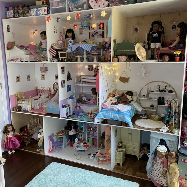 a doll house filled with lots of dolls and toys in it's rooms,