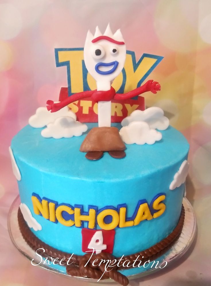 a birthday cake with a toy story character on top and the words nicholas above it