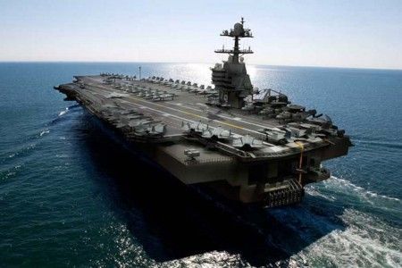 an aircraft carrier in the middle of the ocean