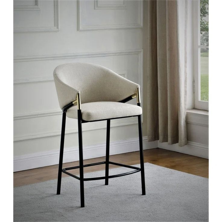 an upholstered bar stool in front of a window