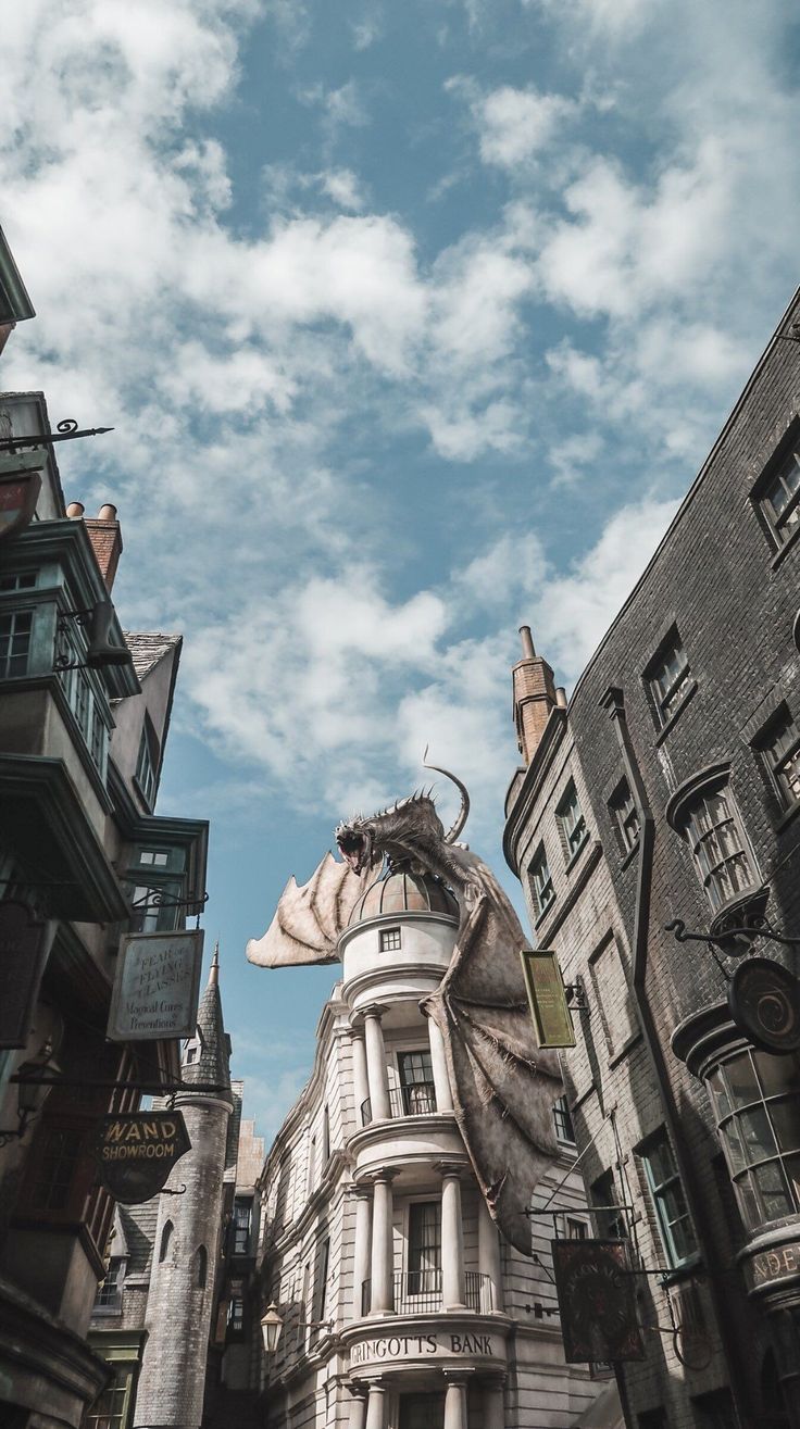 an image of a city street with tall buildings and clouds in the sky above it