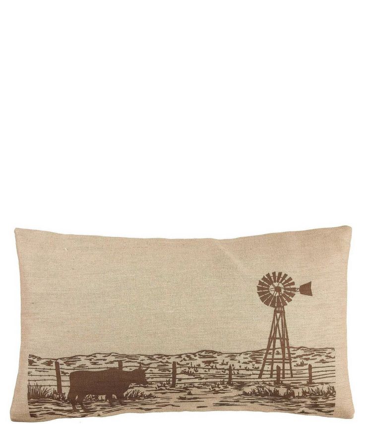 a pillow with an image of a windmill and cows on the field in front of it