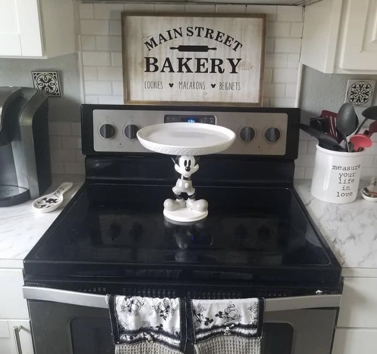 a black stove top oven sitting inside of a kitchen next to a white countertop