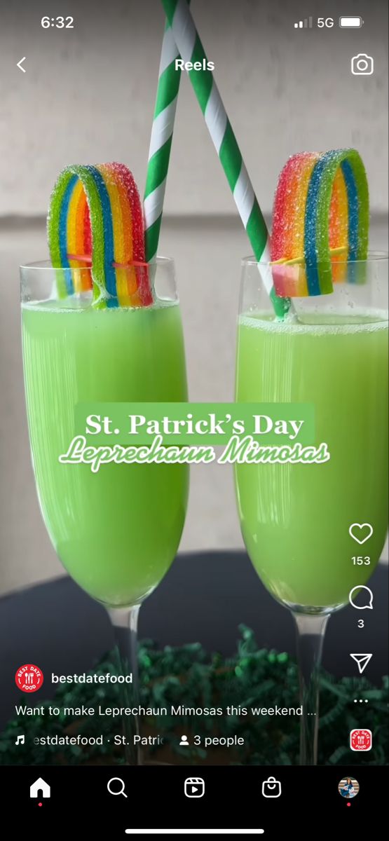 two glasses filled with green liquid and candy canes on top of each glass, sitting next to each other