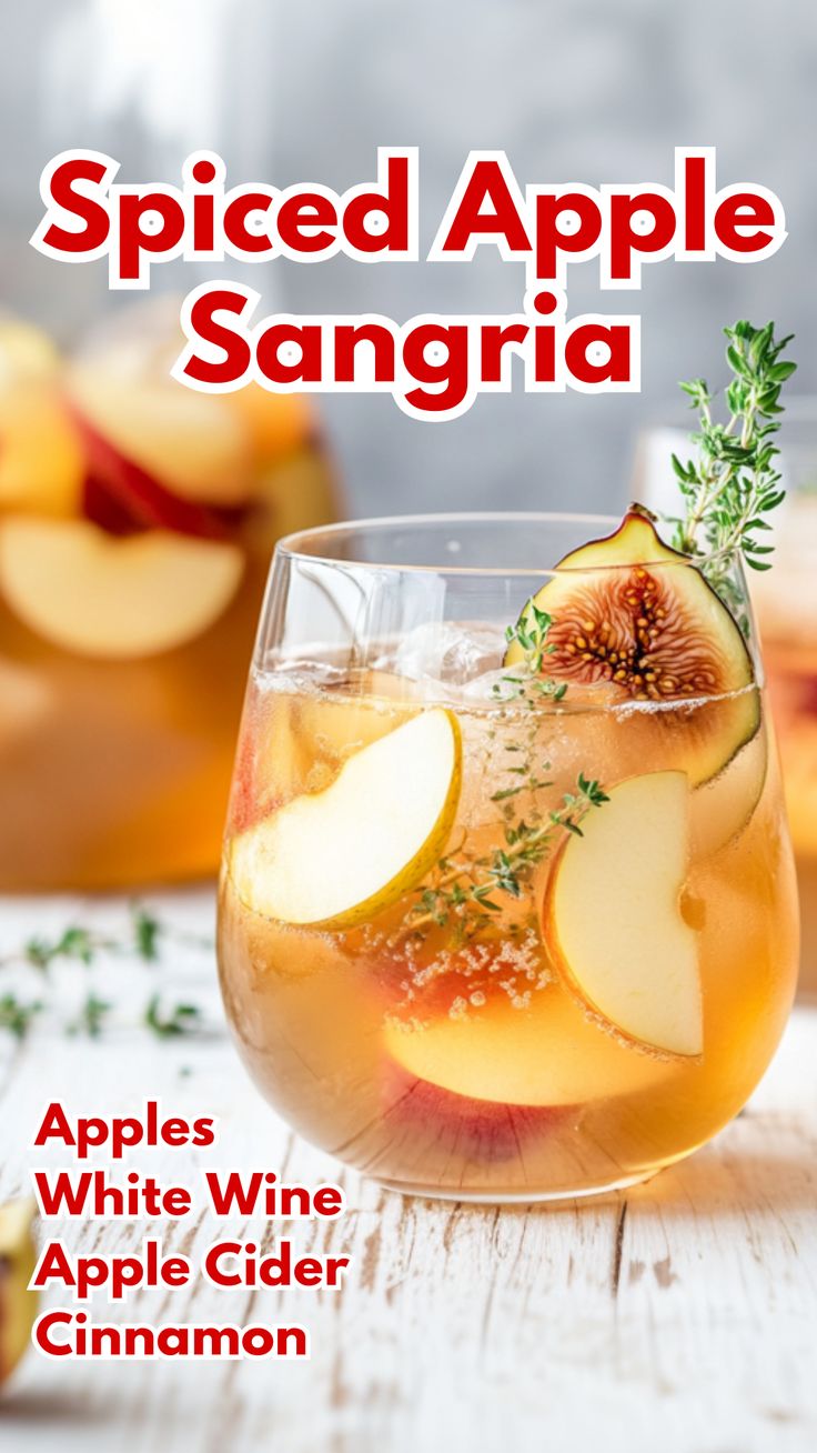 an apple sangria in a wine glass with apples and cinnamon garnishes