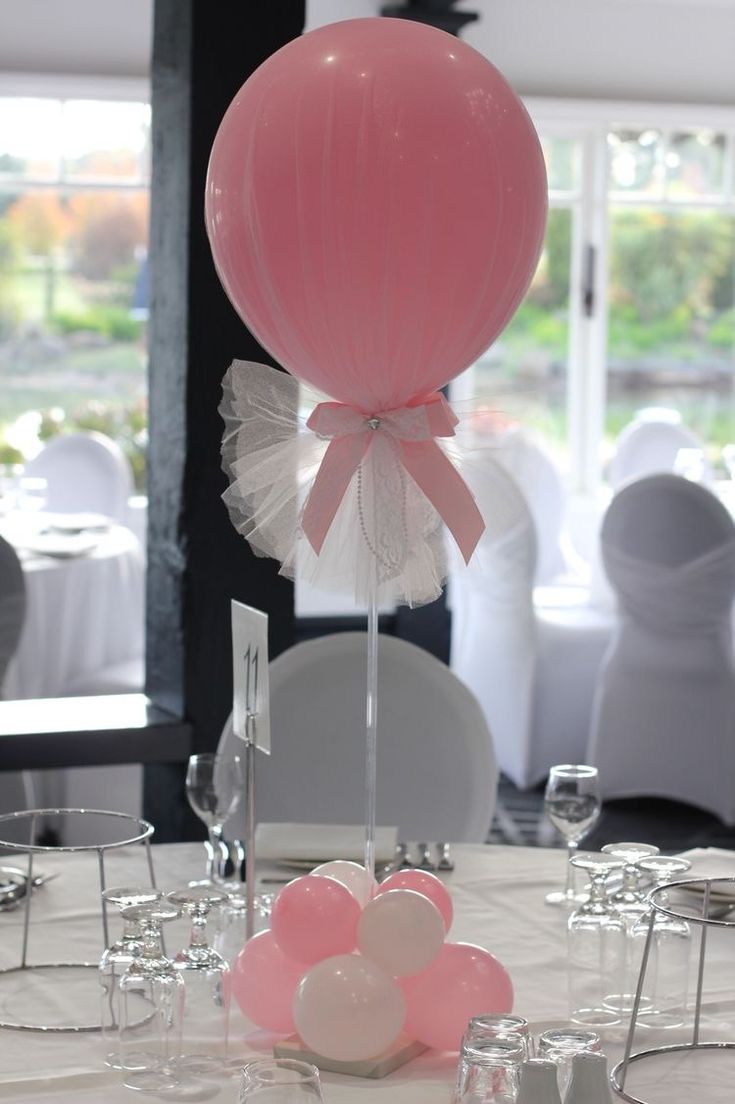 a table set up with balloons and wine glasses for a wedding or special event reception