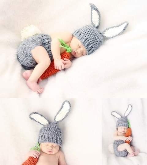 a baby wearing a crocheted bunny hat and diaper laying on top of a bed