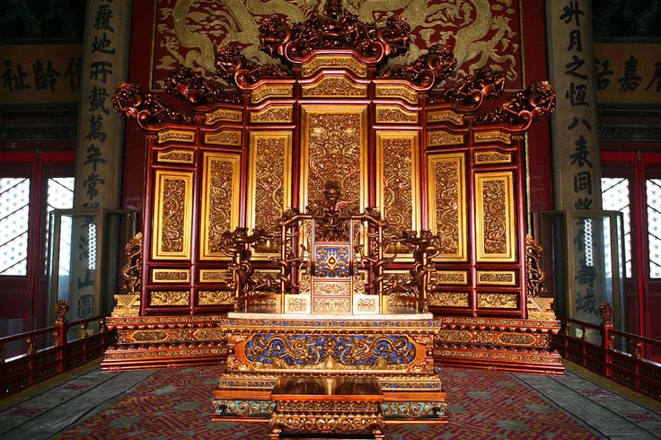 an elaborately decorated altar in a large room with red and gold paint on the walls