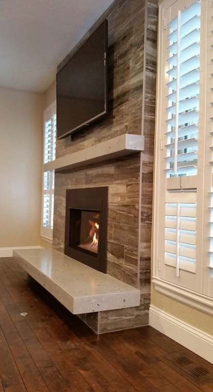 a fireplace with a flat screen tv mounted on it's wall above the fire place