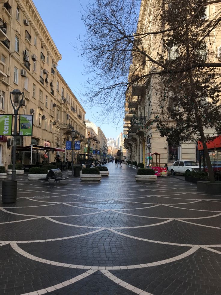 an empty city street with people walking on it