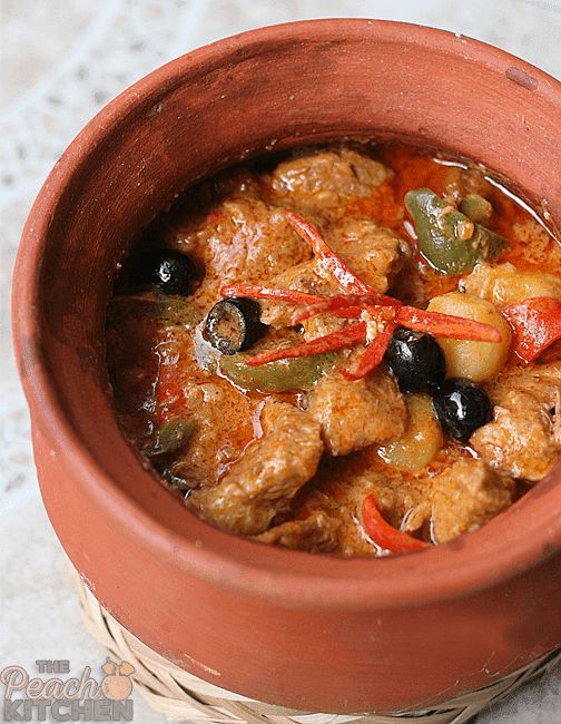 a pot filled with meat and vegetables on top of a table