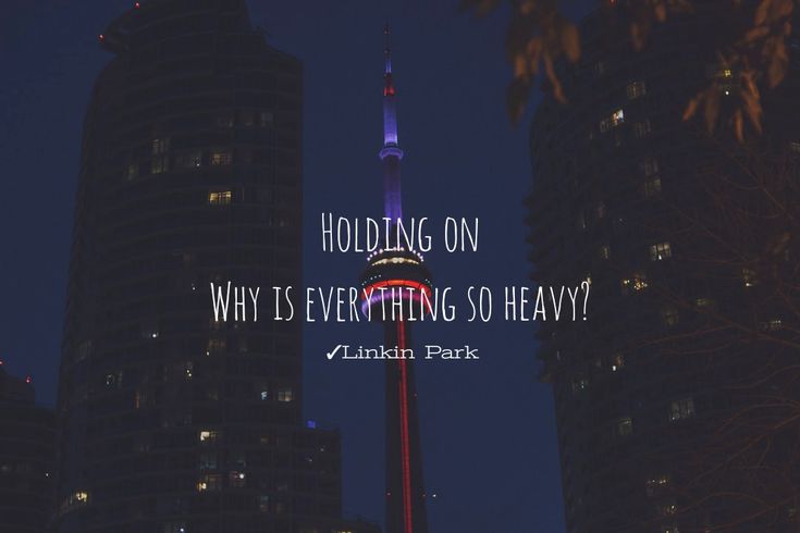 a tall building with the words holding on why is everything so heavy? linkin park