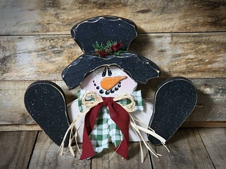 a snowman made out of wood and fabric