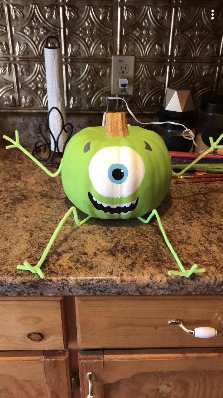 a green monster pumpkin sitting on top of a counter