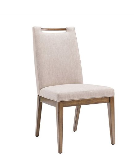 the side view of a dining chair with beige upholstered back and wooden legs