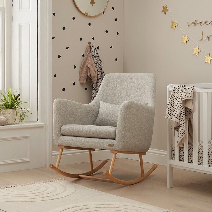 a baby's room with a rocking chair and stars on the wall